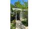 Inviting home entrance with a pergola and walkway, framed by lush greenery and a well-kept lawn at 204 Kirkwood Dr, Chapel Hill, NC 27514