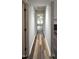 Hallway featuring wood-look flooring leading to a room with a fireplace and a connecting room at 204 Kirkwood Dr, Chapel Hill, NC 27514