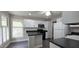 Well-lit kitchen with white cabinets, modern appliances, and sleek countertops, offering a functional and stylish space at 204 Kirkwood Dr, Chapel Hill, NC 27514