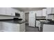 Modern kitchen with white cabinetry, stainless steel appliances, and dark countertops, providing a clean and efficient design at 204 Kirkwood Dr, Chapel Hill, NC 27514
