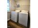 Functional laundry room with white washer and dryer units, a window, and vinyl floors at 204 Kirkwood Dr, Chapel Hill, NC 27514