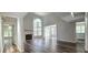 Bright living room with a fireplace, vaulted ceilings, hardwood floors, and access to the outdoors at 204 Kirkwood Dr, Chapel Hill, NC 27514