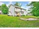 Exterior back view featuring a large lush yard, deck, and mature trees at 212 Spearhead Pl, Clayton, NC 27520