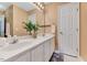 Well-lit bathroom with a double sink vanity, large mirror, and a decorative houseplant at 212 Spearhead Pl, Clayton, NC 27520