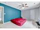 Large bedroom with a ceiling fan, neutral carpet and an accent wall at 212 Spearhead Pl, Clayton, NC 27520