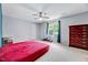 Cozy bedroom with a ceiling fan, a large window, and classic wood dresser at 212 Spearhead Pl, Clayton, NC 27520