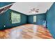 Spacious bedroom featuring hardwood floors, ceiling fan, and natural light at 212 Spearhead Pl, Clayton, NC 27520