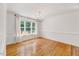 Bright dining room with hardwood floors, chandelier, and large windows overlooking the backyard at 212 Spearhead Pl, Clayton, NC 27520