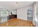 Open-concept dining room with hardwood floors, natural light, and adjacent living room and kitchen at 212 Spearhead Pl, Clayton, NC 27520