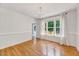 Dining room featuring hardwood floors, modern chandelier, and bright natural light at 212 Spearhead Pl, Clayton, NC 27520