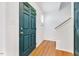 Bright foyer featuring hardwood flooring, white walls, and a solid wood front door at 212 Spearhead Pl, Clayton, NC 27520