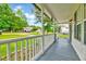 A covered front porch featuring a painted wood floor and a beautiful view of the neighborhood at 212 Spearhead Pl, Clayton, NC 27520