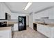 Efficient kitchen with white cabinets, stainless appliances, and durable modern floors at 212 Spearhead Pl, Clayton, NC 27520