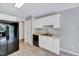 Functional kitchen with white cabinets, black appliances, and durable tile flooring at 212 Spearhead Pl, Clayton, NC 27520