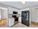 Contemporary kitchen with stainless steel oven and refrigerator, and white cabinets at 212 Spearhead Pl, Clayton, NC 27520
