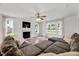 Comfortable living room featuring a cozy fireplace, hardwood floors, and lots of natural light at 212 Spearhead Pl, Clayton, NC 27520