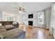 Spacious living room with hardwood floors, a ceiling fan, fireplace, and natural light at 212 Spearhead Pl, Clayton, NC 27520