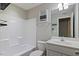 Bathroom showcasing tub-shower combo, decorative wall art, and single sink vanity at 215 Outwater Ridge Dr, Garner, NC 27529