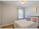 Cozy bedroom with large window, decorative picture on wall, and plush throw pillows at 215 Outwater Ridge Dr, Garner, NC 27529