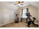 Bright bedroom with exercise equipment, a ceiling fan, and a large window at 215 Outwater Ridge Dr, Garner, NC 27529