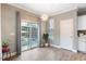 Light-filled dining area with modern chandelier, access to outdoor patio, and wood-look flooring throughout at 215 Outwater Ridge Dr, Garner, NC 27529
