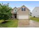 Charming home featuring a two-car garage, well-manicured lawn, and inviting front porch at 215 Outwater Ridge Dr, Garner, NC 27529