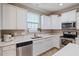 This kitchen boasts sleek white cabinets, modern appliances, and bright countertops, blending style with functionality at 215 Outwater Ridge Dr, Garner, NC 27529