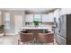 Open-concept kitchen with island, white cabinetry, stainless-steel appliances, and barstool seating for casual dining at 215 Outwater Ridge Dr, Garner, NC 27529
