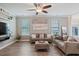 Bright living room with ceiling fan, large windows, modern décor, and stylish furnishings at 215 Outwater Ridge Dr, Garner, NC 27529