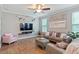 Inviting living room featuring a sectional sofa, hardwood flooring, and a wall-mounted TV at 215 Outwater Ridge Dr, Garner, NC 27529