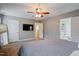 Spacious main bedroom featuring a ceiling fan, gray walls, and access to the ensuite bathroom at 215 Outwater Ridge Dr, Garner, NC 27529