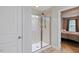 Glass-enclosed shower with a tiled surround and view into adjacent bedroom at 215 Outwater Ridge Dr, Garner, NC 27529