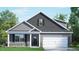 Charming two-story home with gray siding, stone accents, and a well-manicured lawn at 2213 Red Admiral Ct, Apex, NC 27539