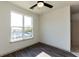 Bright bedroom with a large window, a modern ceiling fan, and wood flooring at 2226 Gathering Sq Ct, Fuquay Varina, NC 27526
