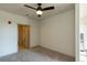 A clean and spacious bedroom includes an ensuite bath and a modern ceiling fan at 2226 Gathering Sq Ct, Fuquay Varina, NC 27526