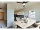 Bright dining area features modern table setting and open view to the kitchen at 2226 Gathering Sq Ct, Fuquay Varina, NC 27526