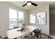 Bright dining room with large windows, a modern ceiling fan, and stylish decor at 2226 Gathering Sq Ct, Fuquay Varina, NC 27526