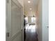Hallway view leads to a kitchen with stainless steel appliances and ample natural light at 2226 Gathering Sq Ct, Fuquay Varina, NC 27526