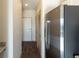 Hallway featuring wood flooring, a closet, and a stainless steel refrigerator at 2226 Gathering Sq Ct, Fuquay Varina, NC 27526
