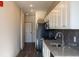 Modern kitchen featuring granite countertops, white cabinets, and stainless steel appliances at 2226 Gathering Sq Ct, Fuquay Varina, NC 27526