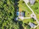 A beautiful aerial view of a home with a pool, lush landscaping, and a circular driveway at 227 Paraggi Ct, Clayton, NC 27527