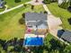 Aerial view of backyard pool and gazebo with lush landscaping, backyard patio and driveway at 227 Paraggi Ct, Clayton, NC 27527