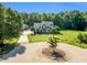Aerial view of a two-story home with a circular driveway and a large, well-maintained lawn at 227 Paraggi Ct, Clayton, NC 27527