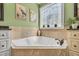 Corner soaking tub features tile surround, decorative tile accents, and plant at 227 Paraggi Ct, Clayton, NC 27527