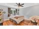 Cozy bedroom featuring hardwood floors, a ceiling fan, and a comfortable chair near the window at 227 Paraggi Ct, Clayton, NC 27527