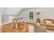 Bonus room with foosball table, hardwood floors, natural light, and comfortable seating, great for entertaining at 227 Paraggi Ct, Clayton, NC 27527