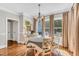 Bright dining room with hardwood floors, chandelier, and a view of the outdoor pool at 227 Paraggi Ct, Clayton, NC 27527