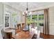 Dining room with hardwood floors, and large windows with a view of the backyard and lots of natural light at 227 Paraggi Ct, Clayton, NC 27527