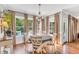 Cozy dining area with hardwood floors, chandelier, and natural light overlooking the pool at 227 Paraggi Ct, Clayton, NC 27527