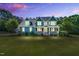 Stunning two-story blue house with a welcoming front porch and beautifully manicured lawn at 227 Paraggi Ct, Clayton, NC 27527